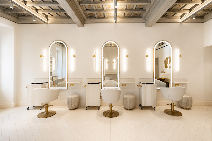 A second view of the arched mirror styling suite with the original wood-beamed frescoed ceiling