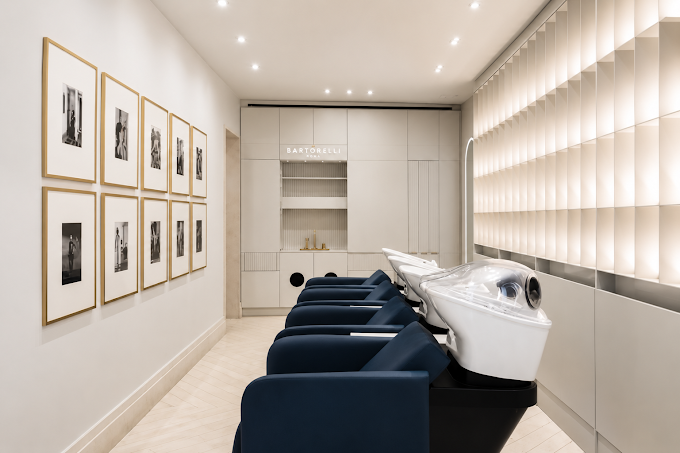 Navy wash chairs beneath a wall gallery of black and white portraits